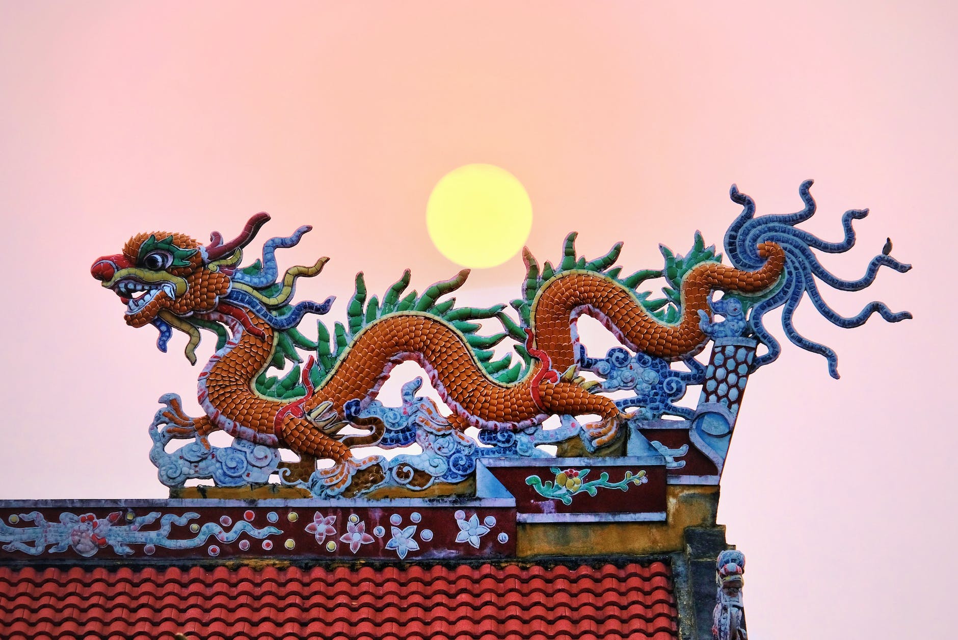 moon over a traditional chinese dragon shaped roof decoration