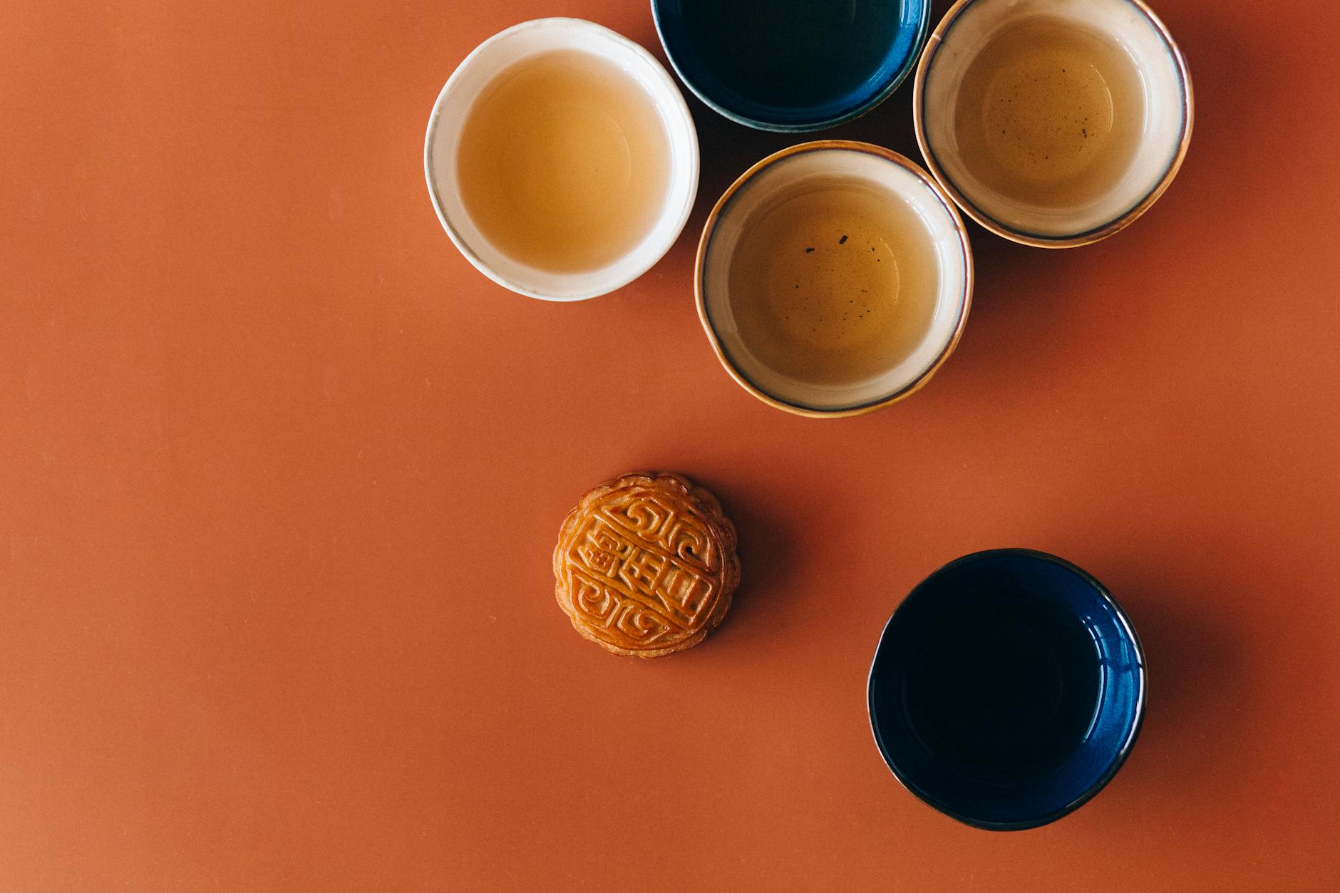 blue ceramic mug beside brown round cookie