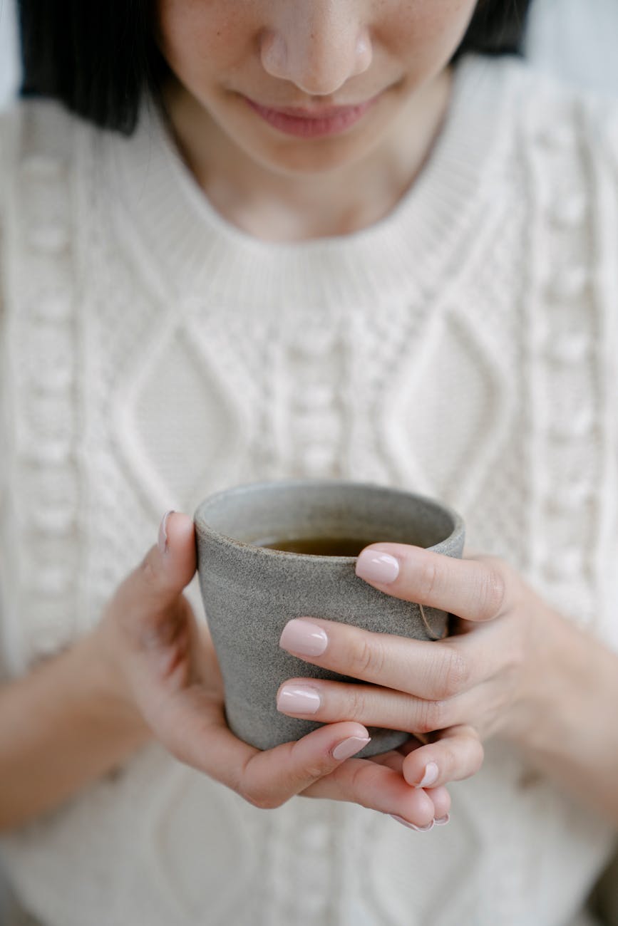 woman with cup of hot herbal tea